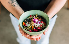 Person holding healthy bowl of muesli from Frank, Hamilton.