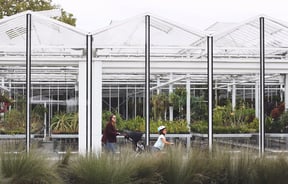Woman with two children walking through the botanical gardens in Christchurch.