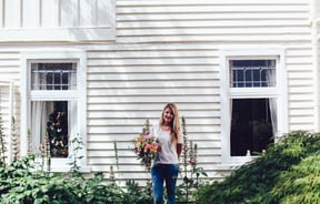 A photo of Natalie-Rose holding a bunch of flowers.