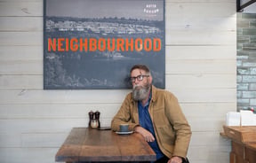Alan Deare sitting in a cafe.