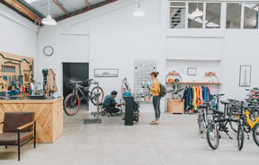 A woman waiting for her bike to be repaired at Action Bicycle Club in Christchurch.