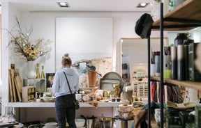 Woman looking at homewares inside Addy & Lou.