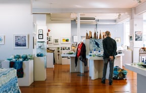 Man looks around ArtsPost Gallery and Shop Hamilton.