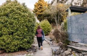 A woman walking with a towel at Awastone in Rangitikei.