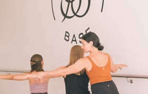 Instructor assisting at Barre Base.