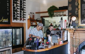 Two people behind the counter at Beach House Cafe.