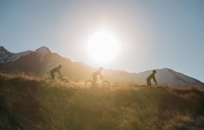 Cycling over grass at sunset.