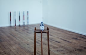Urn on a stand on the wooden floor.