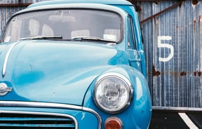 Retro blue car outside.