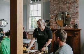Waitress serving a table at Carnegie's Restaurant and Bar, Fairlie.