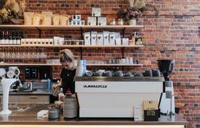 A barista making coffee.