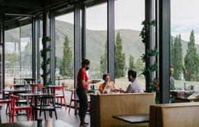Waitress serving a table at Dark Sky Diner, Tekapo.