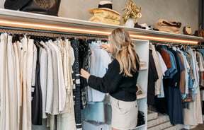 A woman looks through a rack of clothing in DEVàl Boutique, Wānaka.