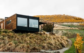 Exterior of Dicey's tasting room set against an autumnal Central Otago landscape.