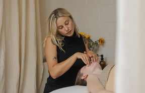 Beauty therapist performing facial massage at Face It in Sumner