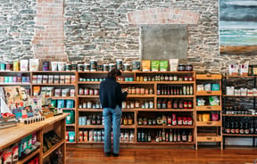 A woman browsing products at Feinerman’s General Store Roxburgh.