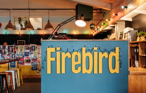 Front counter and tables behind at Firebird Cafe.