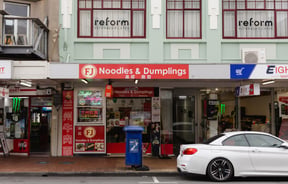 Bright red exterior of FJ Noodles & Dumplings.