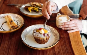 A close up of a muffin and coffee.