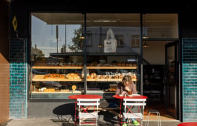 A customer dining outside Florets Bakery Auckland on a sunny day.