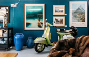 Vintage scooter and furniture inside a retail store.