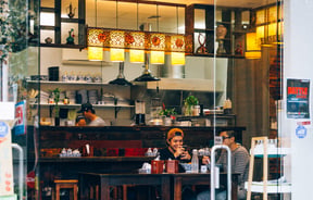 Two customers at a table in Garden Place Noodle Bar, Hamilton.