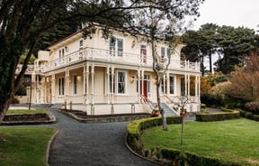 Gear Homestead building exterior set amongst lush gardens