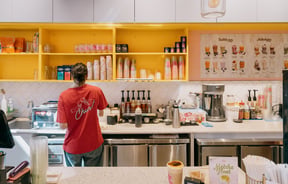 Staff member working behind counter of Gelato & Tea in Christchurch