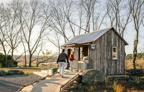 Customers walk up to small cottage building at Gorge Quarter.