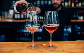 Barman pouring two rosés.