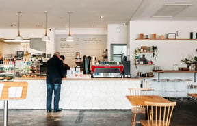A customer paying at the counter at Grey Street Kitchen.