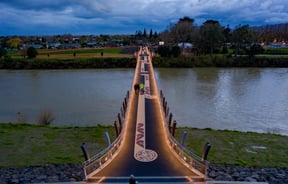 The He Ara Kotahi Bridge at night.