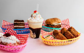 Burgers and thick shakes against a white background.