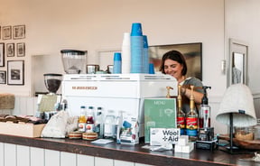 A woman behind a coffee machine at Honest Wolf in Rangitikei.