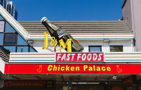 Colourful signage on the exterior of J & M Fastfood.