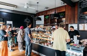 Customers waiting to order at the counter at Janus Bakkerij.