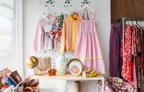 Pink and yellow clothes on a wall.