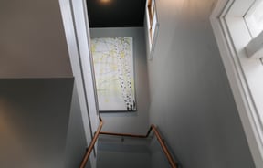 Artwork on the wall by staircase.