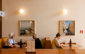 Diners at booth seating at Local Talent Taverna.