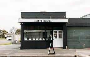 Black building on the corner of the street housing Mabel Vickers.