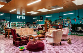 Sofa area with bookshelves behind in Mewington's Book Shoppe.