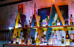 Alcohol on coloured shelves inside.