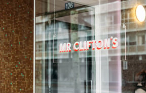 A 'Mr Clifton's' sign on a glass window.