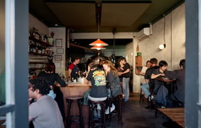 Looking through the doorway into a busy dining room at OOH-FA in Auckland