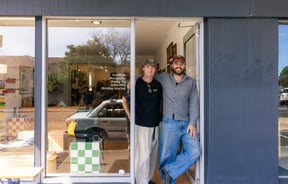 Owners of Outdoors Society standing in entranceway of shop in Auckland