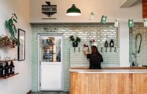 Woman filling rigger with beer and takeaway bar section of Parrotdog in Wellington