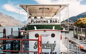 A 'floating bar' sign on a boat.