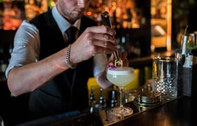 Bartender making drinks.