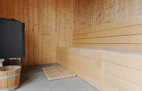 Inside a wooden seder cladded sauna at the Rabbit Island Huts.