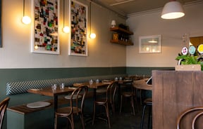 A white and green painted wall inside Ragtag Auckland.